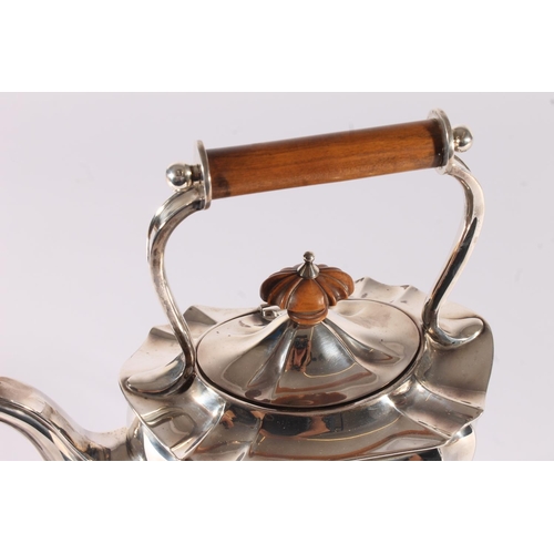 13 - George V silver spirit kettle, of typical shape, the turned wooden handle and finial over a shaped b... 