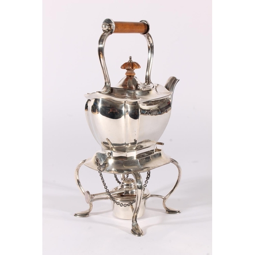 13 - George V silver spirit kettle, of typical shape, the turned wooden handle and finial over a shaped b... 