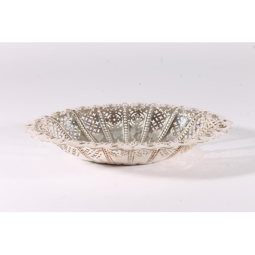 16 - Victorian silver basket form bowl, the oval bowl with wavy rim over a pierced and embossed interior,... 