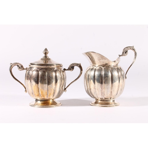 18 - Mexican sterling silver tray, cream and sugar bowl, mid 20th century, of reeded form with cast scrol... 