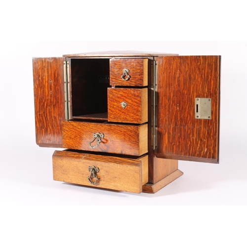 400 - Oak smoker's cabinet, early 20th century, the door opening to reveal drawers and fitted compartments... 