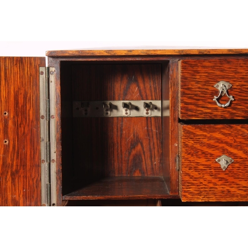 400 - Oak smoker's cabinet, early 20th century, the door opening to reveal drawers and fitted compartments... 