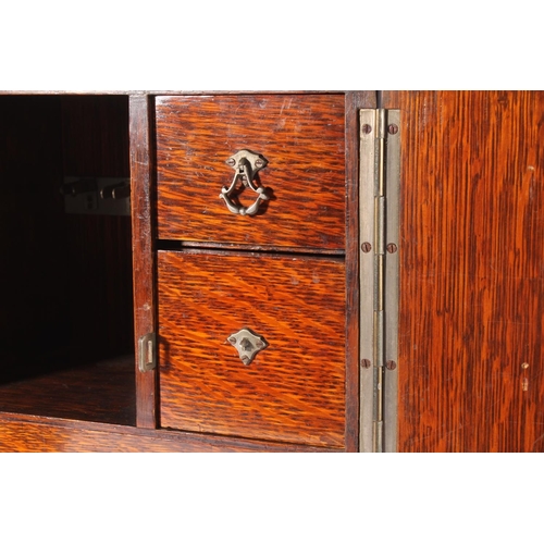 400 - Oak smoker's cabinet, early 20th century, the door opening to reveal drawers and fitted compartments... 