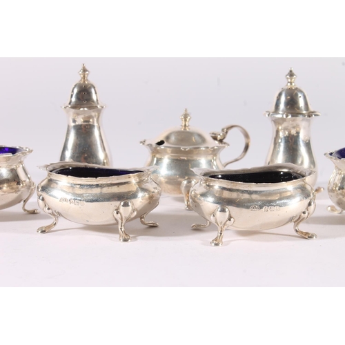 22 - George V seven piece silver cruet set, all with conforming pie crust edges, bulbous bodies over scro... 