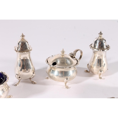 22 - George V seven piece silver cruet set, all with conforming pie crust edges, bulbous bodies over scro... 