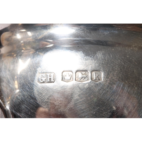 26 - George V silver sauce boat, with shaped rim, open scroll handle and shell shouldered pad feet, Harri... 