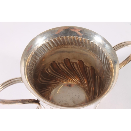 30 - Edwardian silver loving cup, the half lobed baluster body on a round pedestal foot with ear shape ha... 