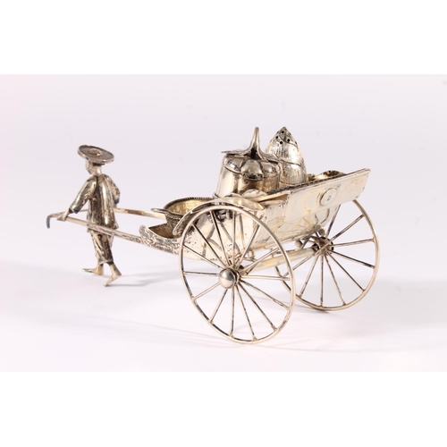 42 - Chinese white metal three-piece cruet set, modelled in the form of a man pulling a rickshaw, fitted ... 