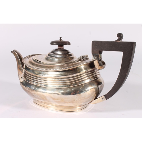 5 - George V silver three-piece tea set, the teapot with angular ebonised handle and ribbed body, the mi... 