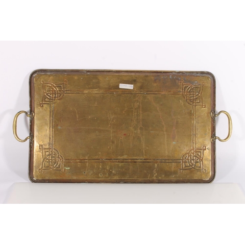 407 - Arts and Crafts style brass tray, the body with repousse knotwork design, 62cm wide.