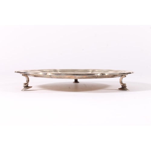 67 - George VI silver waiter or salver with piecrust edge raised on three scroll supports terminating in ... 