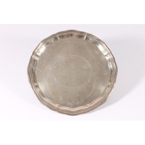 67 - George VI silver waiter or salver with piecrust edge raised on three scroll supports terminating in ... 