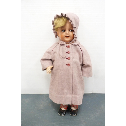 177 - German composition doll with clothing, by Kammer & Reinhardt, on a Chippendale-style doll's chai... 