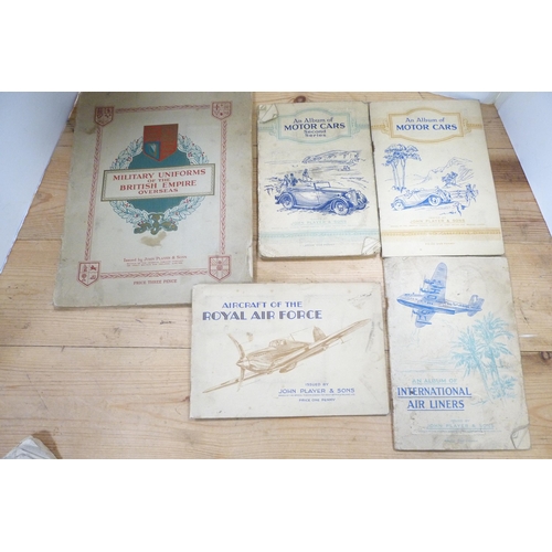 204 - Group of ephemera to include cigarette card albums by John Player & Sons, on motor cars and Mili... 