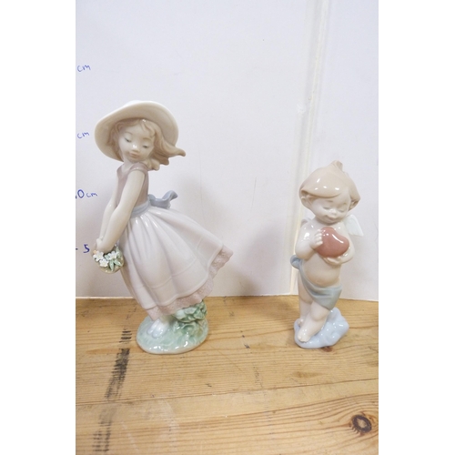 205 - Four Lladro figures modelled as an Eskimo child with baby polar bear, girl holding basket of flowers... 