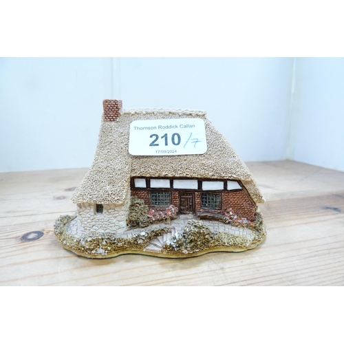 210 - Group of model thatched cottages and buildings, mostly by Lilliput Lane.  (7)