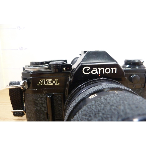 212 - Canon AE-1 camera with attached Tamron micro lens, with spare Canon lenses and accessories in fitted... 