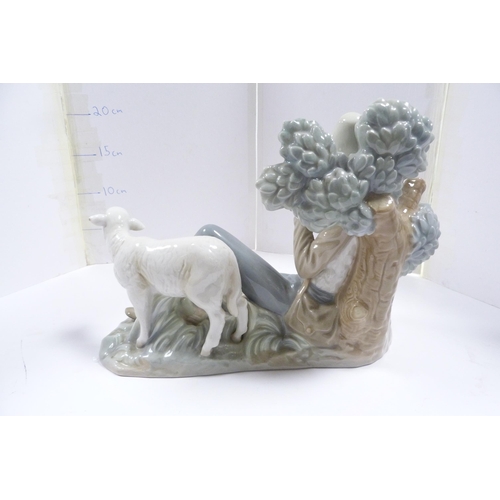 240 - Lladro figure group modelled as a male playing pan pipes, with a sheep and dog alongside.