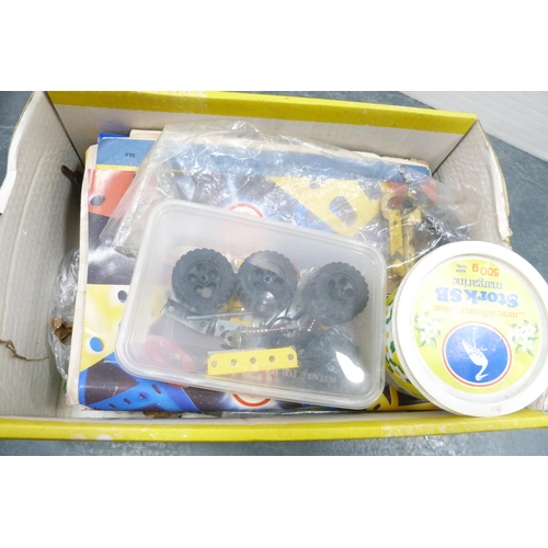 25 - Three cartons containing loose Meccano accessories to include cogs, wheels, plates etc.