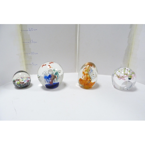 265 - Four art glass paperweights to include a candy cane example.  (4)