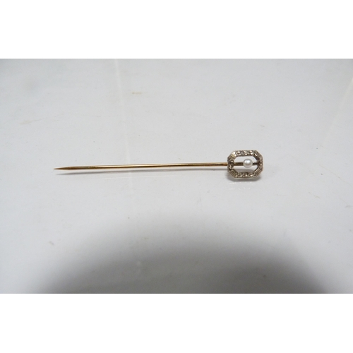 282 - 14k white gold stick pin, the yellow metal pin unmarked, set with a seed pearl, in fitted case.