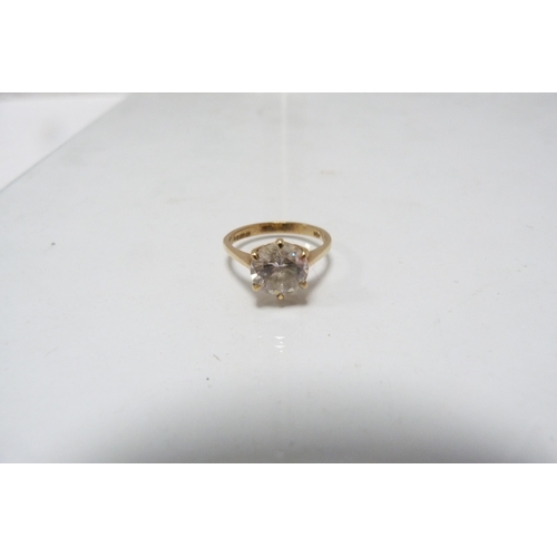 285 - 9ct gold lady's solitaire ring set with a faux gemstone, 3g gross.