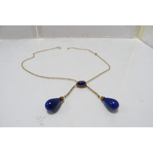 287 - 9k gold chain with attached lapis-style and yellow metal pendants, 8.5g gross.