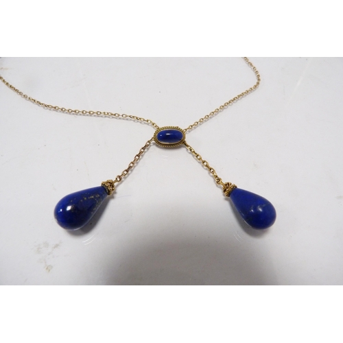 287 - 9k gold chain with attached lapis-style and yellow metal pendants, 8.5g gross.