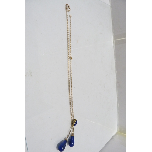 287 - 9k gold chain with attached lapis-style and yellow metal pendants, 8.5g gross.