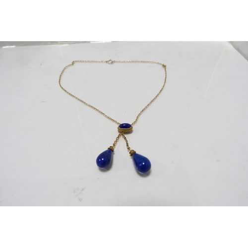 287 - 9k gold chain with attached lapis-style and yellow metal pendants, 8.5g gross.