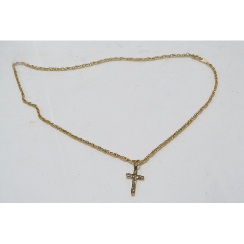 288 - 9ct gold cross pendant attached to a yellow metal chain, two other 9ct gold pendants, gold weight ap... 