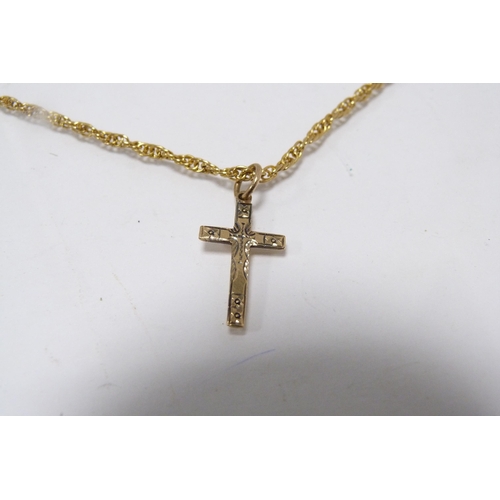 288 - 9ct gold cross pendant attached to a yellow metal chain, two other 9ct gold pendants, gold weight ap... 