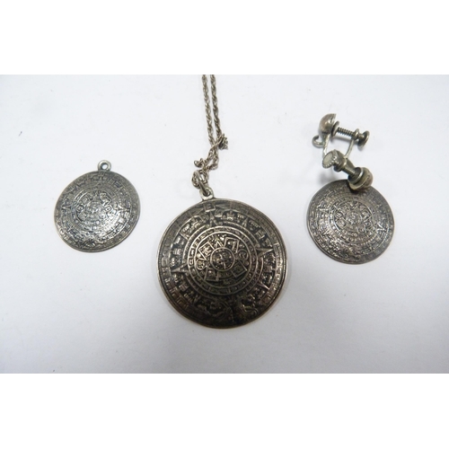 302 - Three Mexican 925 silver Aztek pendants, graduated sizes, approximately 12g gross, a Mexican coin-mo... 