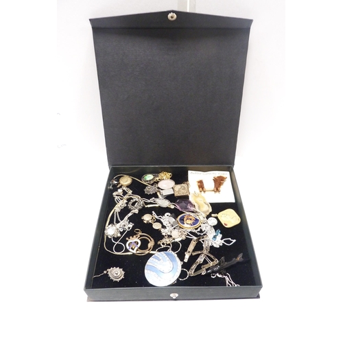 314 - Quantity of costume jewellery brooches, badges, cufflinks, necklaces etc., contained in a vanity cas... 