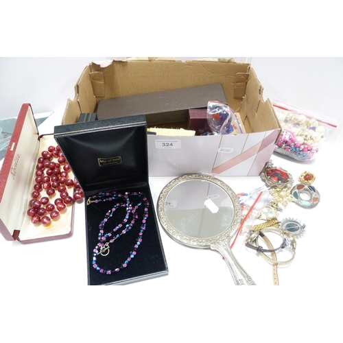 324 - Box of costume jewellery to include bead necklaces, brooches, wristwatches etc., also a brush set.