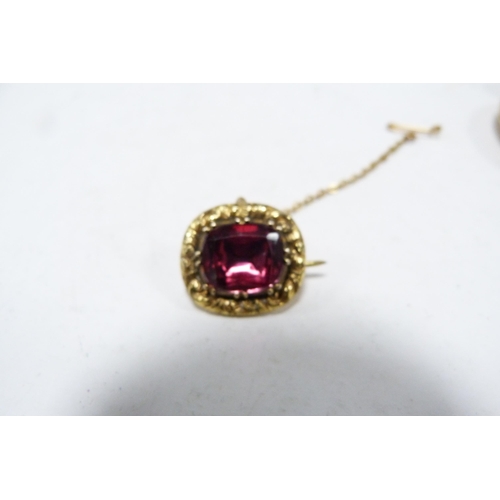 326 - Antique unmarked pink topaz-set brooch with safety chain, and a locket.  (2)