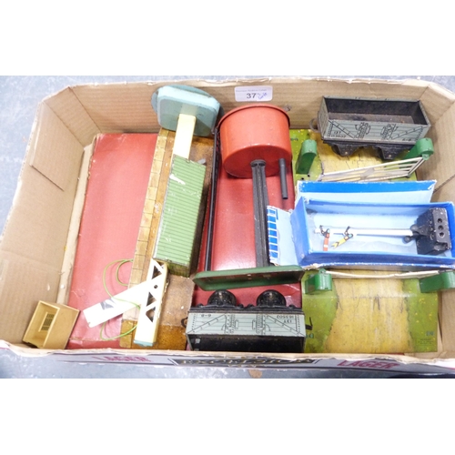 37 - Three cartons containing a collection of model railway buildings, accessories, tinplate building, bo... 