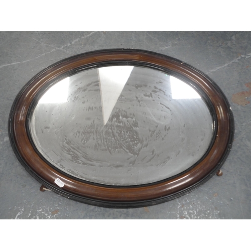 381 - Oak coffee table on castors and an oval wall mirror. (2)