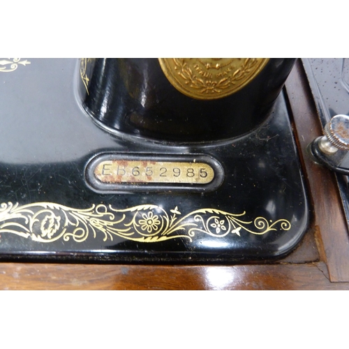 65 - Singer portable sewing machine in fitted case, no. EB652985.