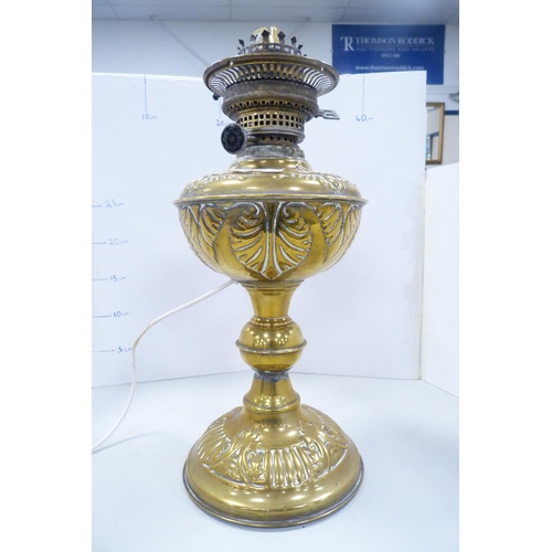 86 - Early 20th century brass oil lamp with later glass shade and funnel, converted to electricity.