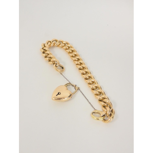 31 - 15ct gold hollow curb bracelet with heart snap. 27g. 