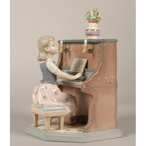 12 - Lladro figure, girl at a piano, 21cm high