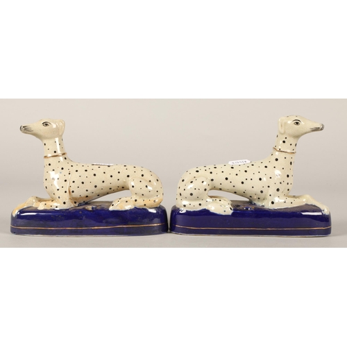 249 - Pair of Staffordshire greyhound quill holders.