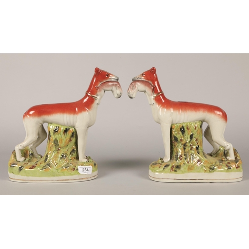 254 - Pair Staffordshire greyhounds with rabbits on naturalistic bases.