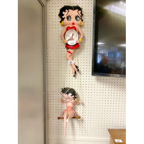 283 - Novelty Betty Boop wall clock and hanging 'swing' figure.