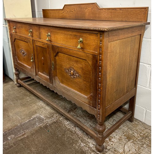 583 - Large carved oak sideboard, H 117cm, W 169cm, D 60cm