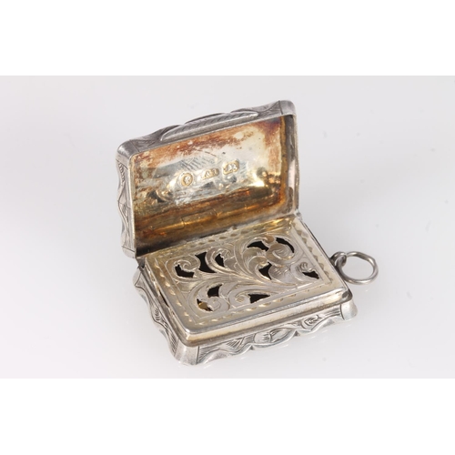 93 - Antique Victorian silver vinaigrette of rectangular shape with serpentine edge, the body decorated a... 