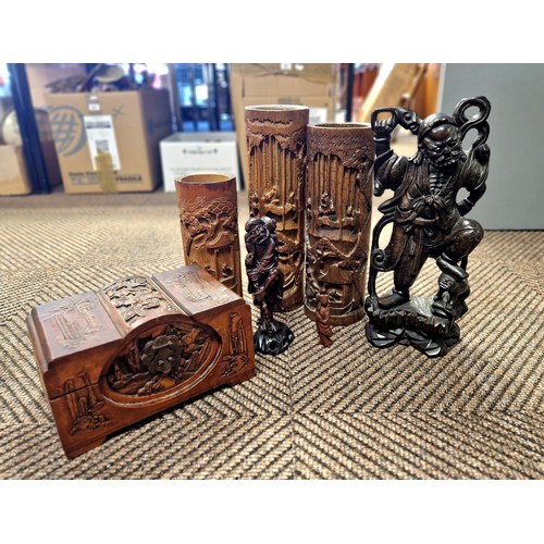 381 - Carved root wood figure and two others, three carved bamboo brush pots, and a carved box.