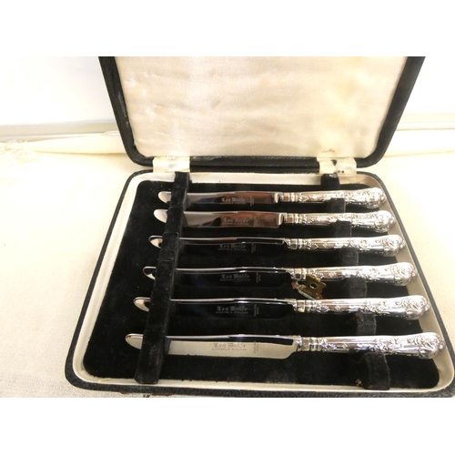 329 - Set of cased silver handled cake knives.