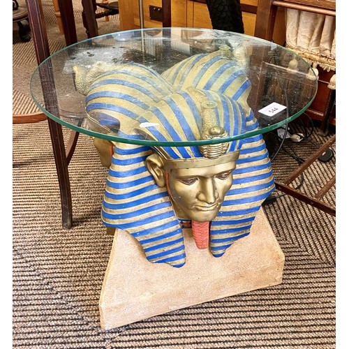 544 - Circular glass side table, the base in form of Tutankhamun